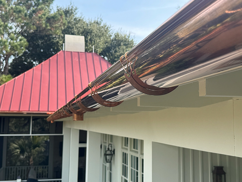 Rain gutter system directing water away from roof edge